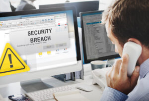 An IT worker being notified of cybersecurity incident and putting the organisation's data breach incident response plan into action